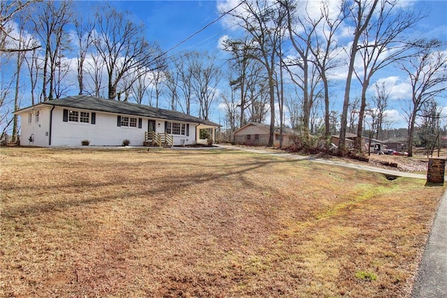 single story home featuring brick siding and a front yard