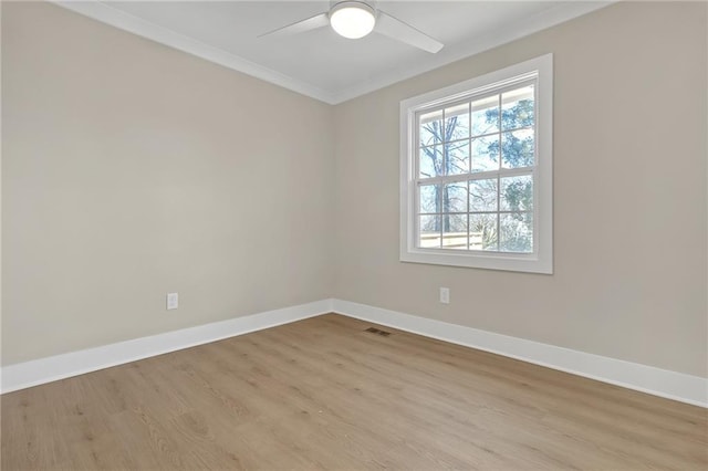 empty room featuring light wood-type flooring, ceiling fan, and crown molding