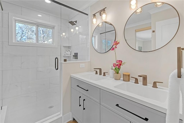 bathroom featuring vanity, a shower with door, and ornamental molding