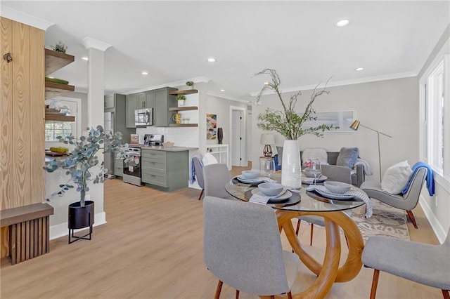 dining area featuring plenty of natural light, light hardwood / wood-style flooring, and ornamental molding