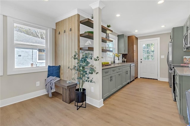 kitchen featuring appliances with stainless steel finishes, gray cabinetry, and light hardwood / wood-style flooring