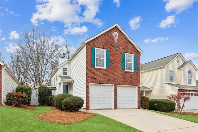 view of property with a garage and a front lawn