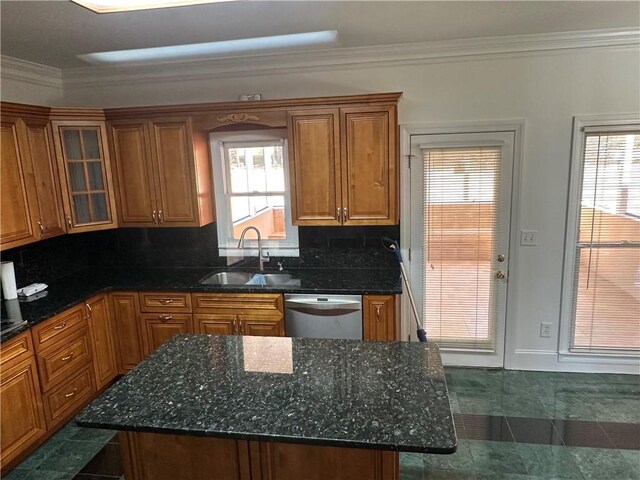kitchen featuring crown molding, dishwasher, brown cabinets, a sink, and backsplash