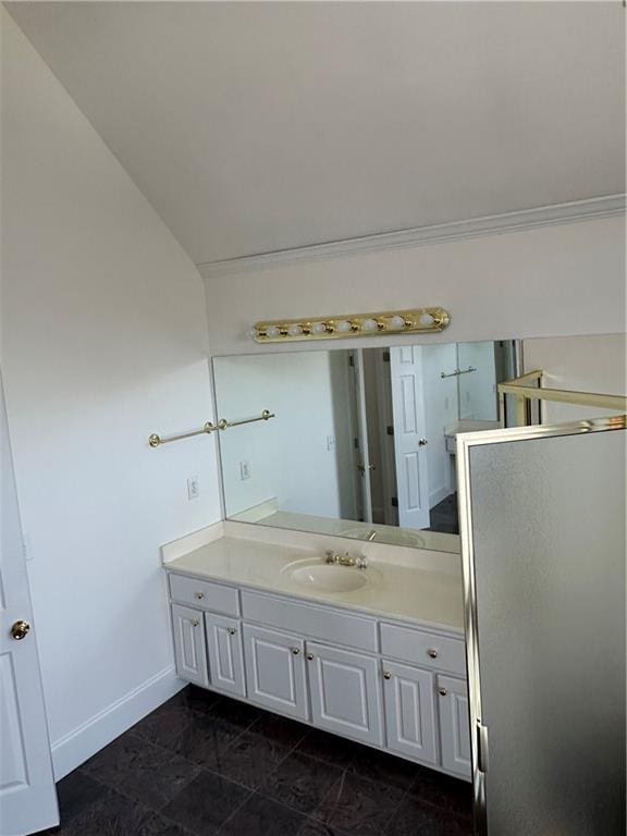 bathroom featuring vanity, baseboards, and lofted ceiling