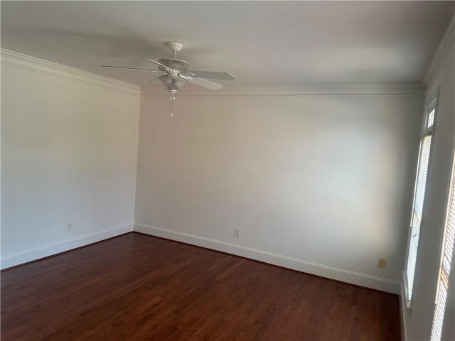 spare room featuring baseboards, crown molding, ceiling fan, and dark wood-style floors