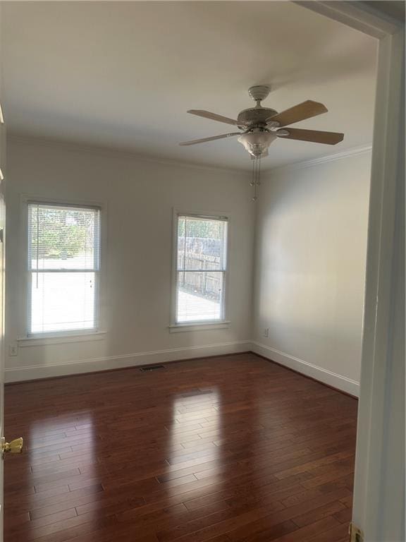 spare room featuring a healthy amount of sunlight, baseboards, and ceiling fan