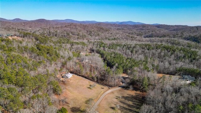 birds eye view of property featuring a mountain view and a view of trees