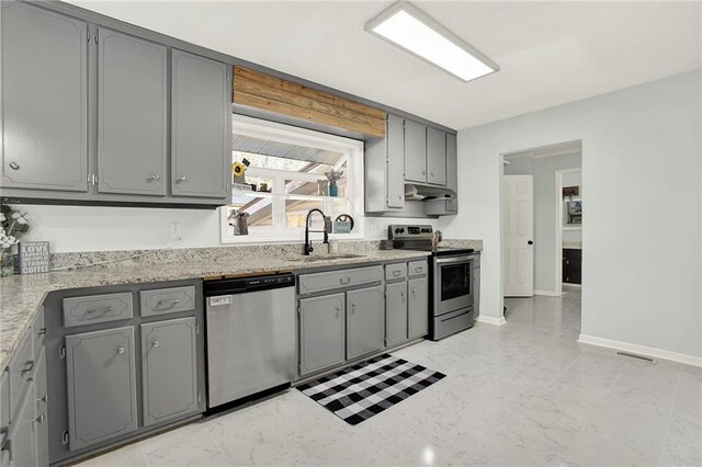 kitchen with gray cabinetry and stainless steel appliances