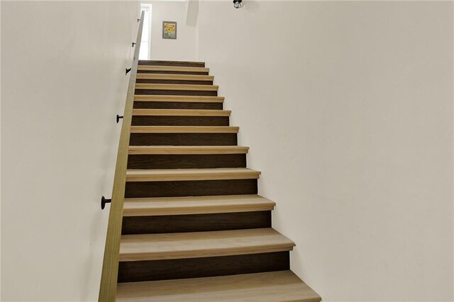 interior space with lofted ceiling, baseboards, visible vents, and dark wood-style flooring