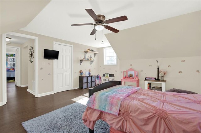 bedroom with baseboards, lofted ceiling, ceiling fan, and dark wood-style flooring