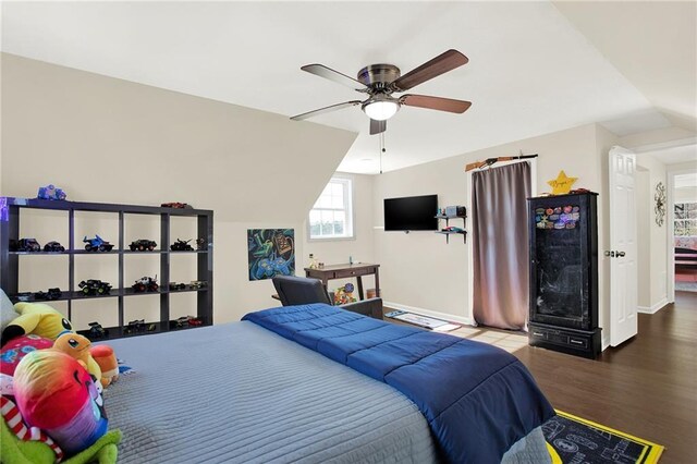 bedroom featuring ceiling fan, baseboards, lofted ceiling, and wood finished floors