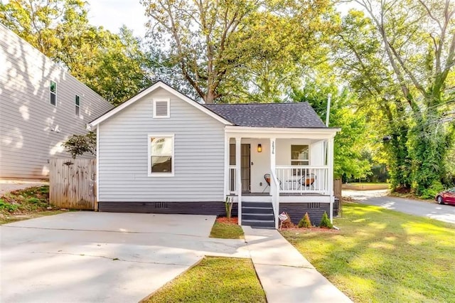 2876 Randall St, East Point, GA 30344 - bungalow featuring covered porch, a front yard, a shingled roof, and crawl space