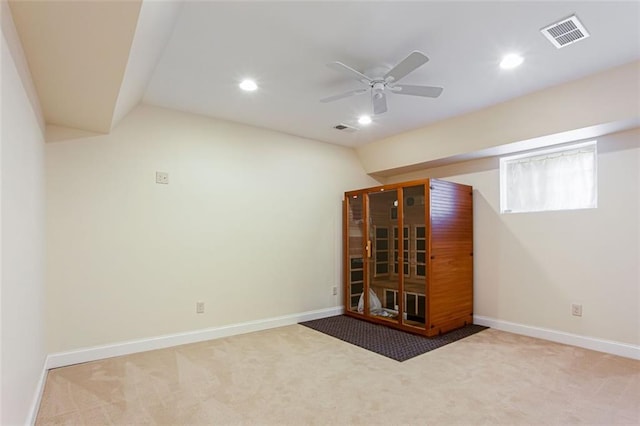 carpeted empty room featuring ceiling fan