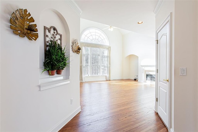 corridor featuring hardwood / wood-style flooring and ornamental molding