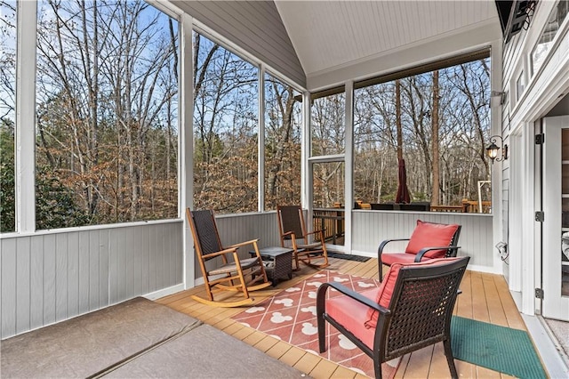 sunroom / solarium featuring vaulted ceiling