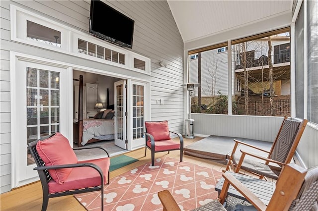 sunroom featuring french doors and lofted ceiling