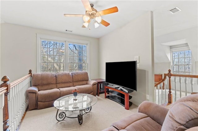 carpeted living room with lofted ceiling and ceiling fan