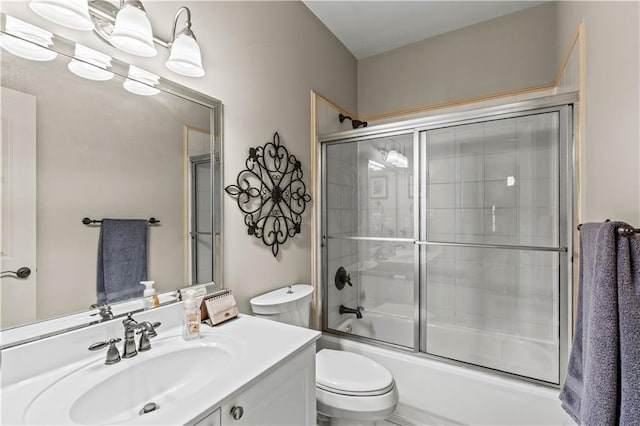 full bathroom with vanity, toilet, and combined bath / shower with glass door