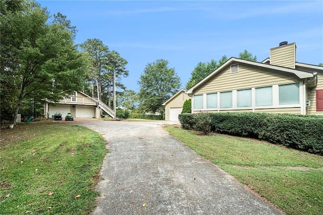 view of side of property with a garage and a yard