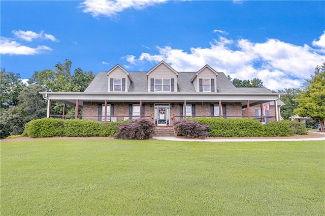 cape cod house featuring covered porch and a front yard