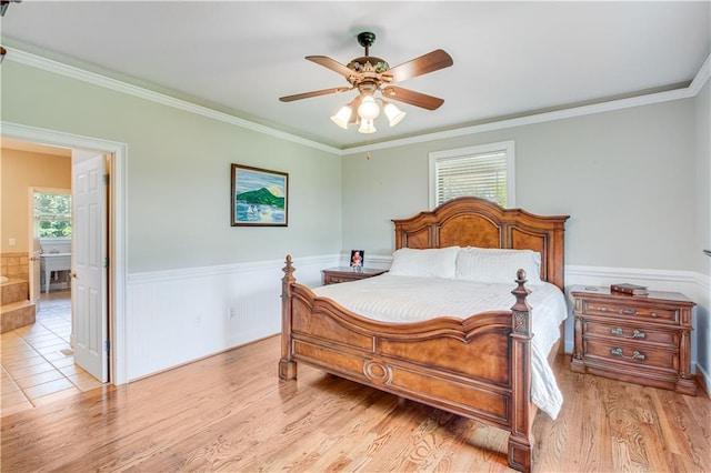 bedroom featuring crown molding, ceiling fan, and light tile floors