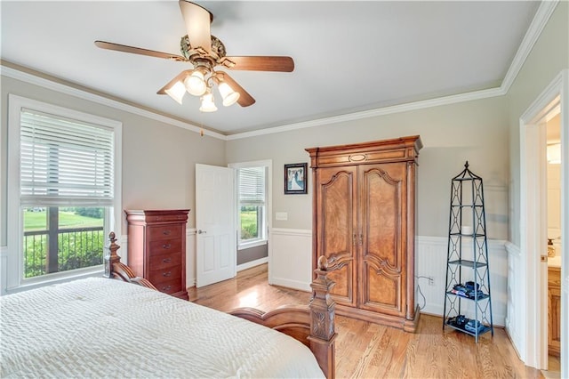 bedroom featuring multiple windows, ornamental molding, ceiling fan, and light wood-type flooring