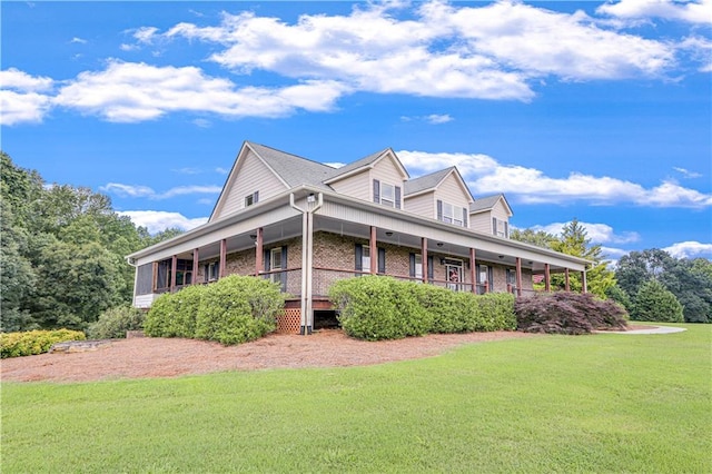 view of side of property featuring a yard and covered porch