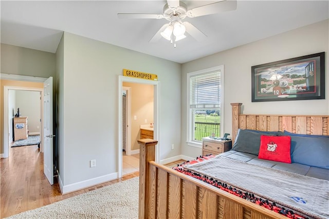 bedroom with ceiling fan, ensuite bathroom, and light hardwood / wood-style flooring