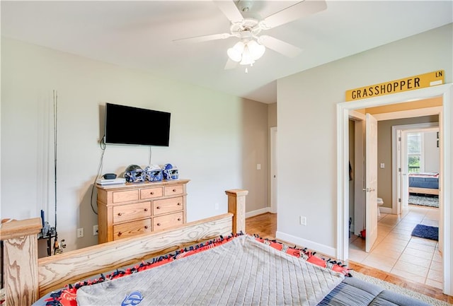 tiled bedroom featuring ceiling fan