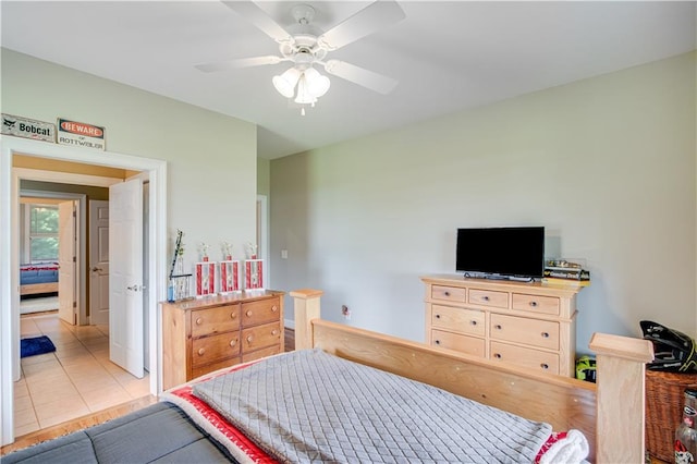 bedroom with ceiling fan and light tile floors