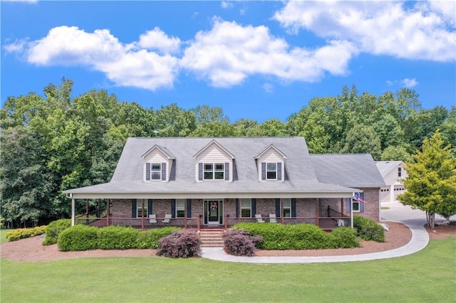 new england style home with a front lawn and covered porch