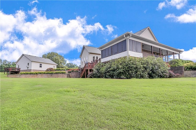 view of side of home with a deck and a yard