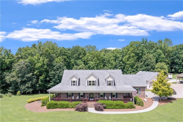 cape cod-style house featuring a front yard and a porch