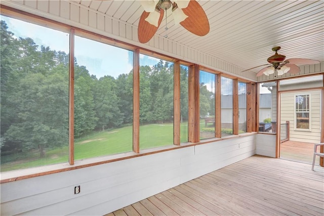 unfurnished sunroom featuring wooden ceiling, ceiling fan, and a wealth of natural light