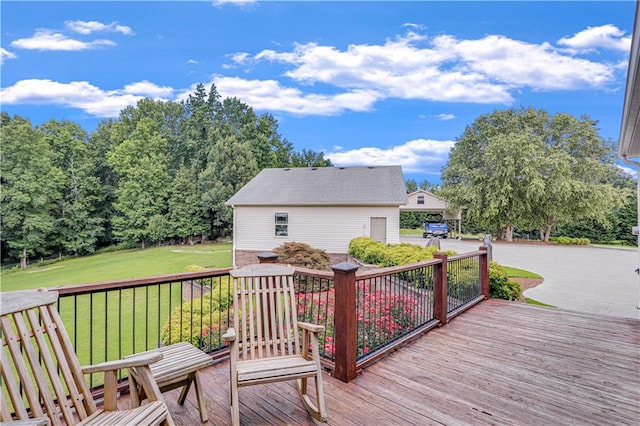 deck featuring a lawn and a garage