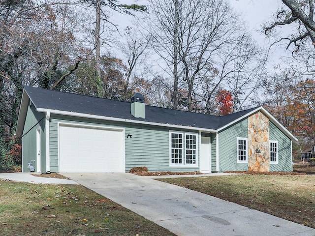 single story home with a garage and a front yard