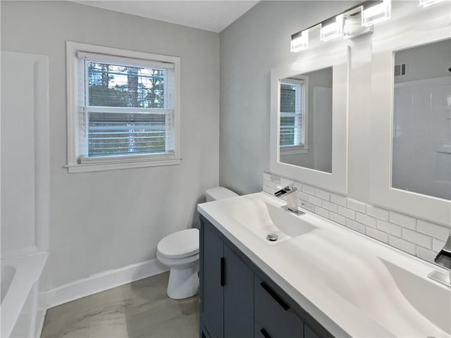 bathroom with vanity, tasteful backsplash, and toilet