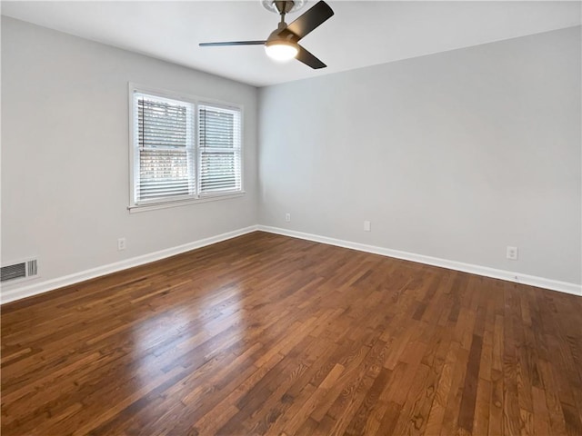 unfurnished room with dark wood-type flooring and ceiling fan