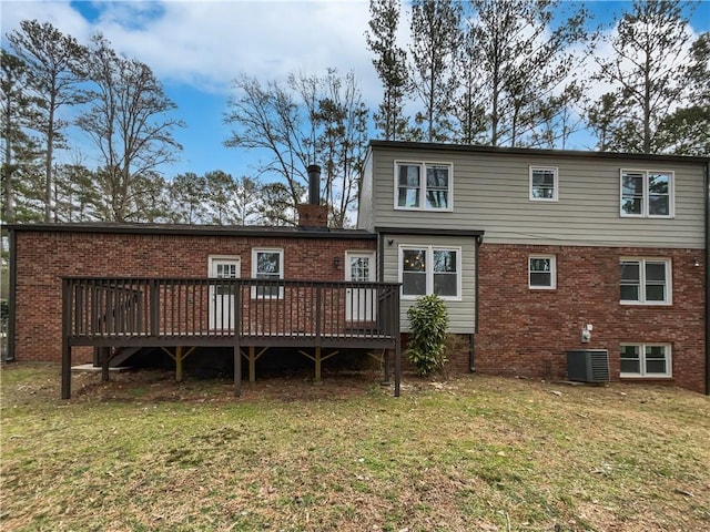 rear view of house featuring central AC unit, a yard, and a deck