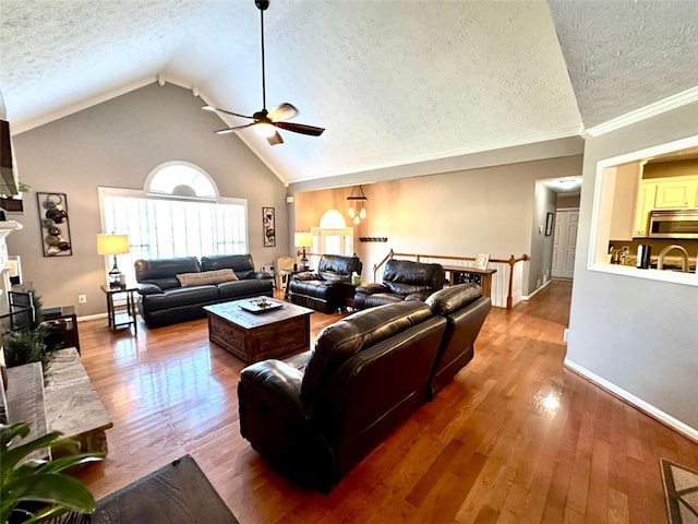 living room with hardwood / wood-style floors, a textured ceiling, and a brick fireplace