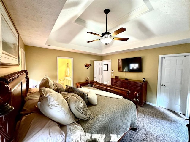 bedroom featuring ensuite bathroom, carpet floors, ceiling fan, and a tray ceiling