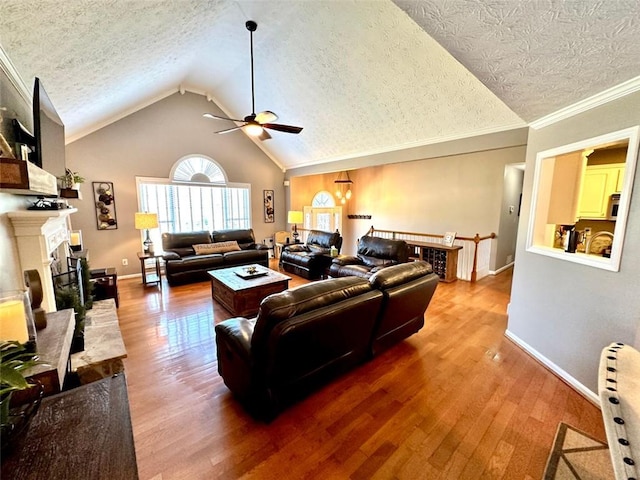 living room featuring a fireplace, hardwood / wood-style flooring, ceiling fan, and a textured ceiling