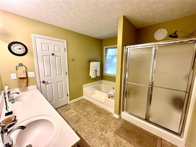 bathroom featuring vanity, a textured ceiling, and shower with separate bathtub