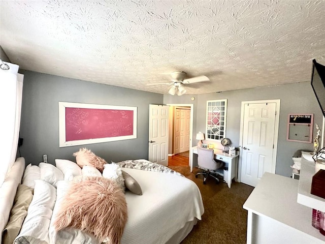 carpeted bedroom with ceiling fan and a textured ceiling