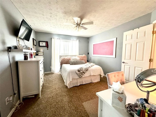 bedroom with a textured ceiling, ceiling fan, and dark carpet