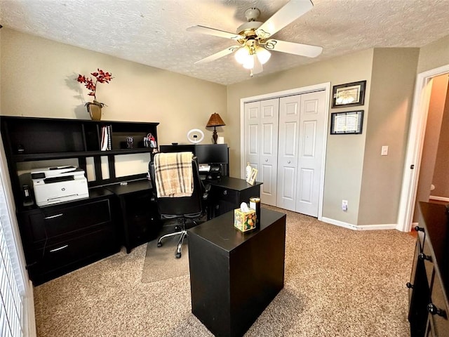 office space with a textured ceiling, ceiling fan, and carpet floors