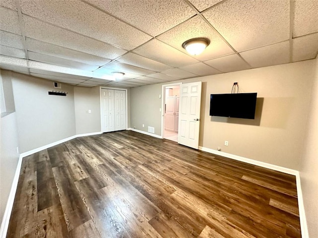 basement featuring hardwood / wood-style flooring and a drop ceiling