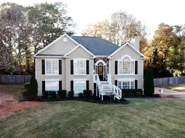 bi-level home with a front lawn