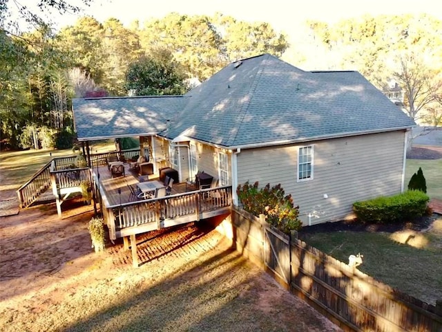 back of property featuring a wooden deck