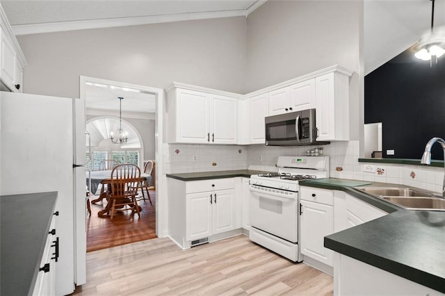 kitchen with white cabinets, white appliances, sink, and light wood-type flooring